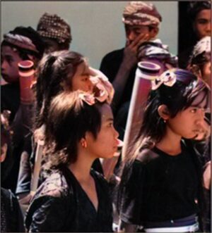 Schoolchildren performing on traditional bamboo instruments